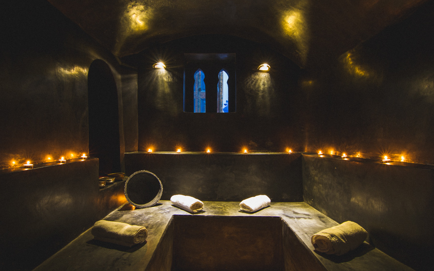 Photography of a Moroccan hammam with towels and candles