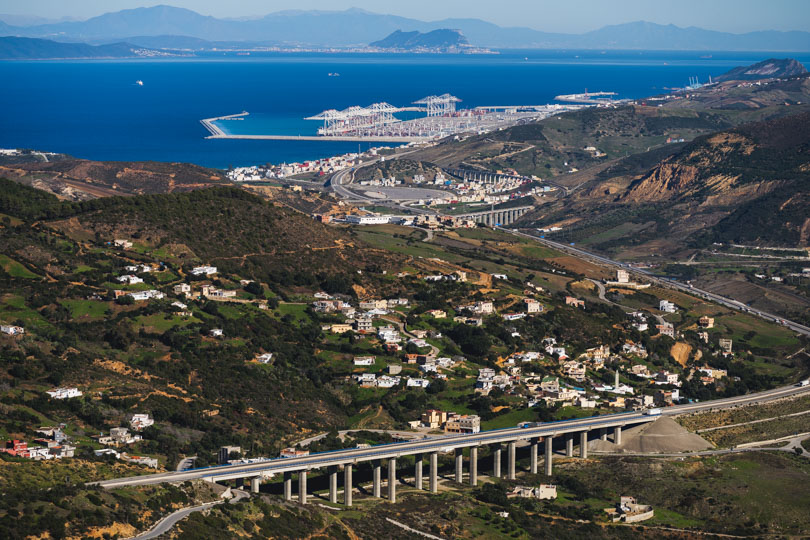Helicopter shot of Highway to tanger med port with straight of gibraltar