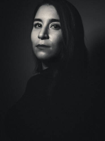 Portrait of female on dark background with retouching